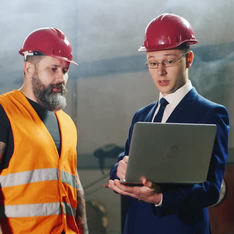 two engineers study drawings work in the warehouse 5