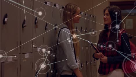 Animation-of-network-of-connections-with-icons-over-caucasian-female-students-talking-in-school