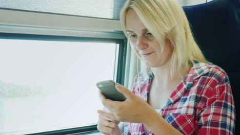 a young woman rides on the second floor of a train sits by the window