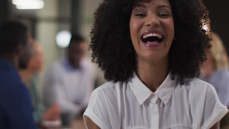 Portrait-of-african-american-businesswoman-in-a-meeting-room-looking-to-camera-laughing