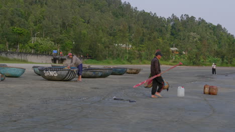 tracking shot of a man carrying a paddle and placing his gear down at da nang