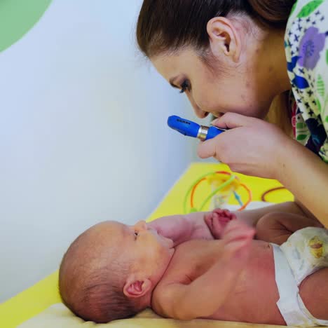 family doctor examines small child. friendly cheerful female pediatrician examines baby