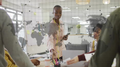 animation of world map and data network over diverse colleagues discussing at casual office