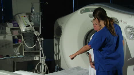 a doctor prepares a patient for a cat scan 5