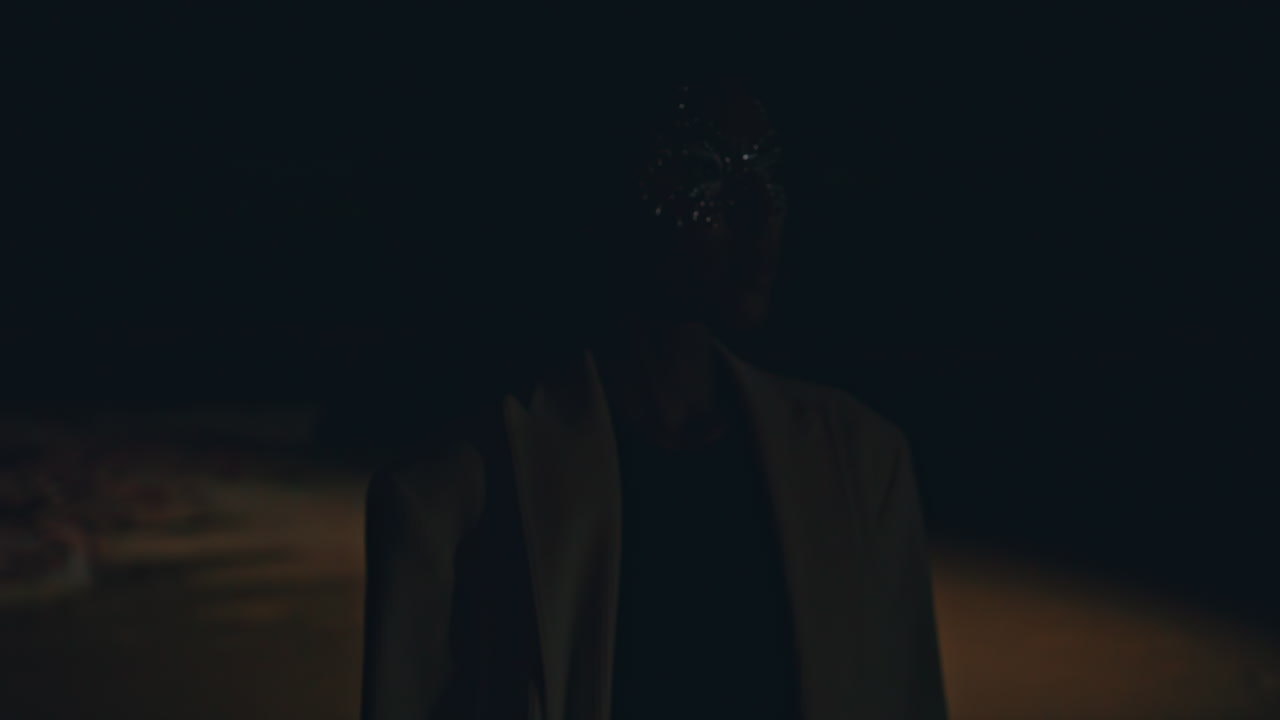 Closeup woman profile silhouette in dark background. Curly fashion model posing