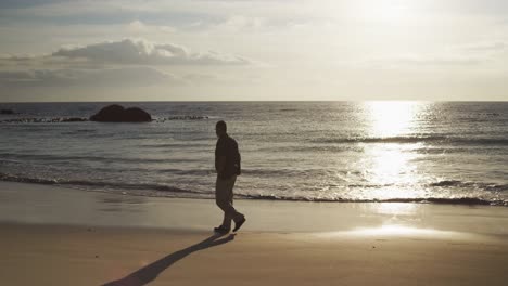 Senior-man-walking-at-the-beach