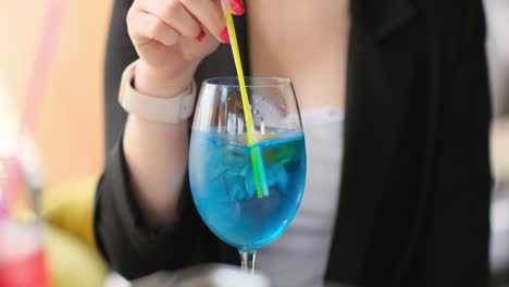 girl-mixes-a-cocktail-with-a-straw