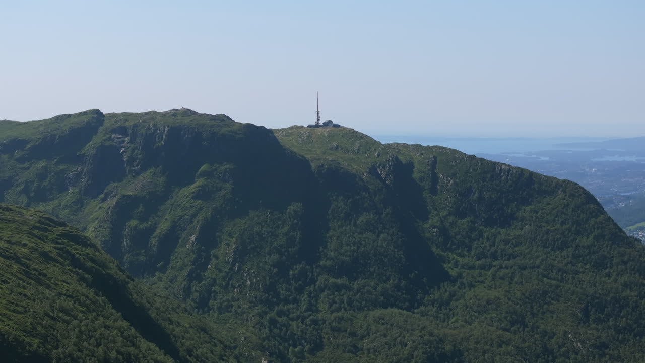 Drone push-in from the northern side, capturing the dramatic slopes of Mount Ulriken and expansive summer scenery in the mountains