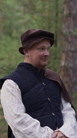 positive man and children wearing traditional medieval clothes in pine forest. ancient village folk. actors and role players at reconstruction set