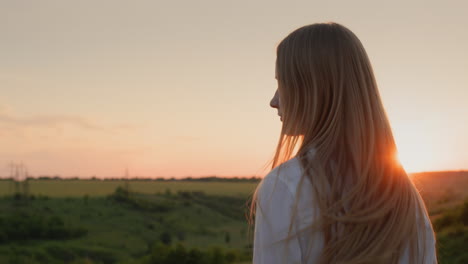 Teenager-Mädchen-Dreht-Bei-Sonnenuntergang-Ihren-Kopf-Und-Ihre-Langen-Haare.-Zeitlupenvideo