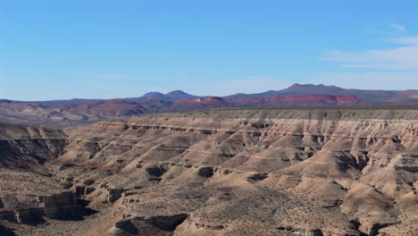 stunning aerial establishing shot showcasing the desert and semi-arid vistas of chubut province in argentina. this patagonian region offers dramatic landscapes and rugged charm.