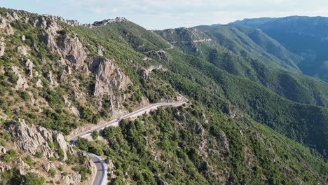 Panoramic-Road-and-Green-Mountains-Cliffs-in-Sardinia,-Italy---Aerial-4k