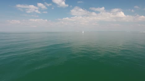 Drone-shot-flying-towards-a-sailboat-over-mediterranean-sea.-Beautiful-sunny