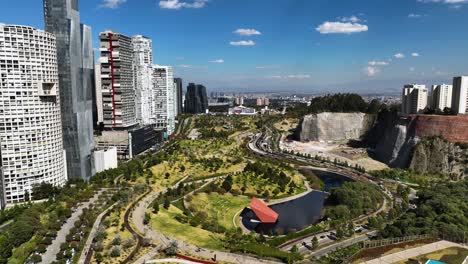 flying over the parque la mexicana park in sunny santa fe, mexico city - aerial view