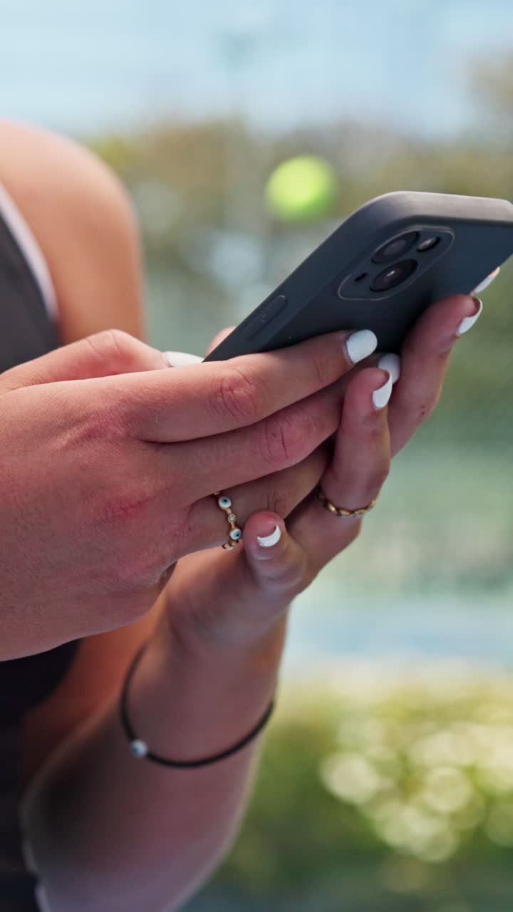 Close Up of Person's Hands Using a Smartphone Outdoors