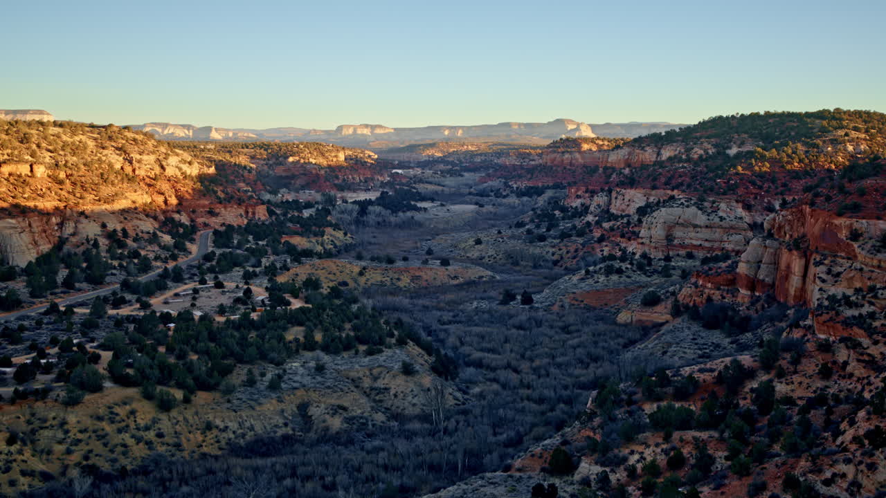 Drone soars above deep canyons near Kanab, Utah, as the first light of day emerges.