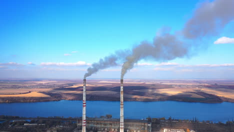 aerial view of smoking factory tubes. industry energy producing air pollution. full length view