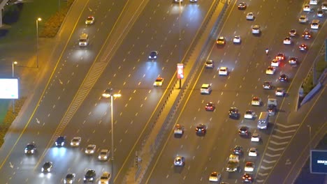 Vehicles-Moving-On-The-Busy-Sheikh-Zayed-Road-In-Dubai,-United-Arab-Emirates-During-Rush-Hour-At-Night---aerial