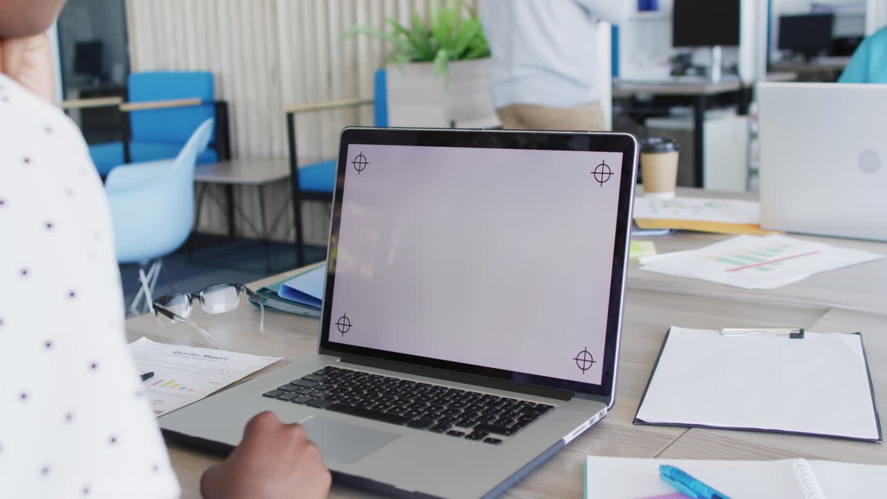 African american businesswoman using laptop with copy space at office, slow motion
