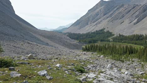 Mountain-pond-valley-pan-to-sun-flare-pan-Rockies-Kananaskis-Alberta-Canada