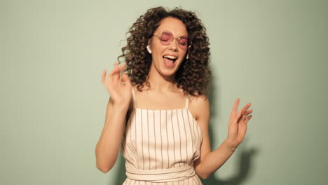 happy woman dancing with headphones and sunglasses