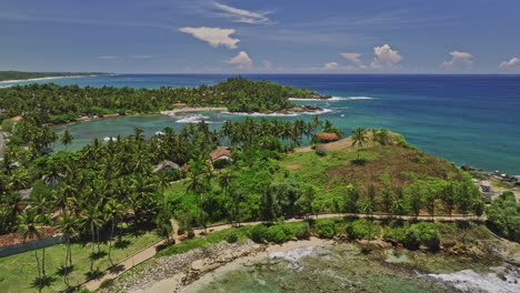 koattagoda sri lanka aerial v3 fly along talalla beach towards seethagalla beach capturing hillside sea views resort hotels and swelling waves and lush palms - shot with mavic 3 cine - april 2023