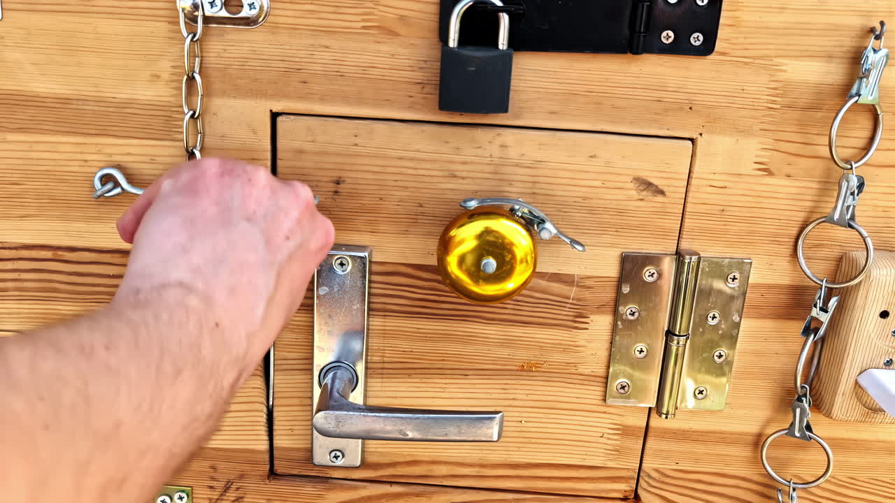 Wooden latch board in closeup with hand locking doors