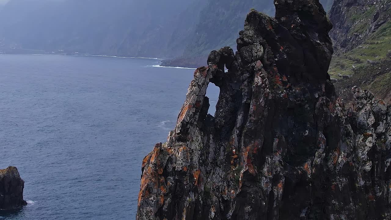 Dramatic coastal rock formation near the ocean in Madeira, Portugal