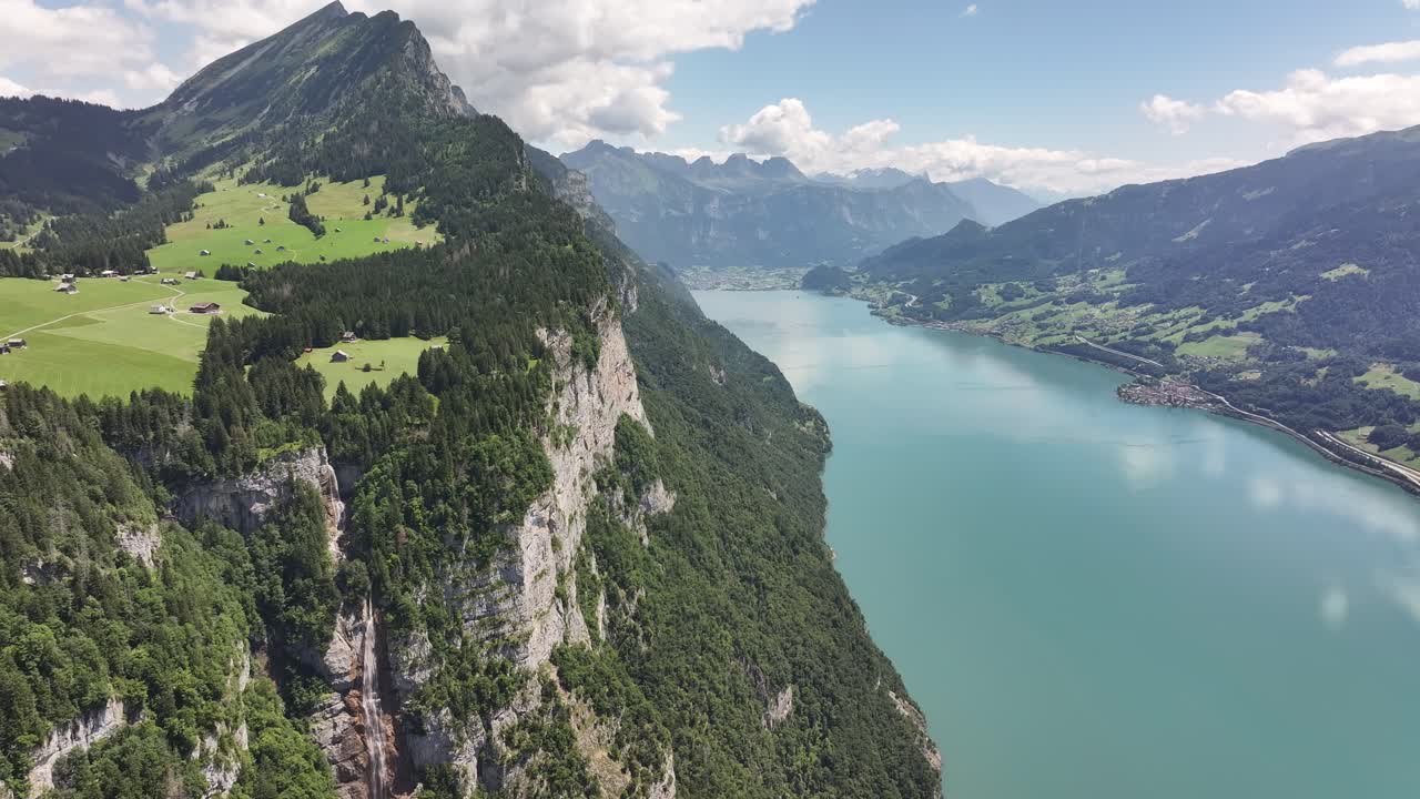 Aerial view of Seerenbach Falls and Walensee with lush green mountains in Amden, Switzerland