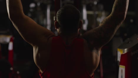 man performing lat pulldown exercise in gym