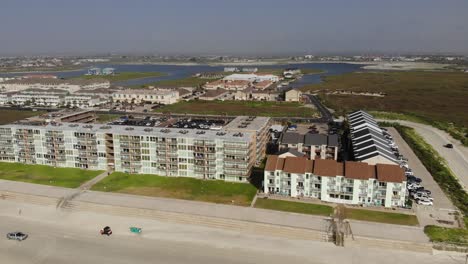 Pan-left-of-the-lodging-of-the-inlet-channel-showing-vehicles-driving-on-the-beach