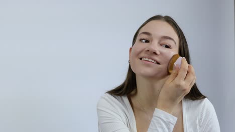 Beautiful-and-attractive-young-woman-applying-makeup-to-her-face