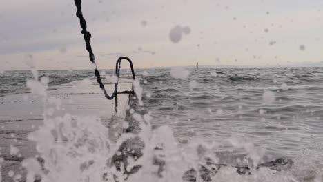 steady upwards camera motion as waves hit the pier