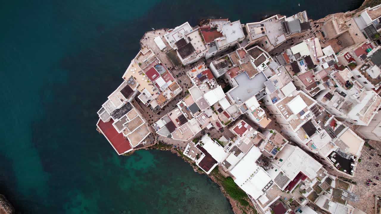 Aerial top down view of Polignano city waterfront building on sea coastline