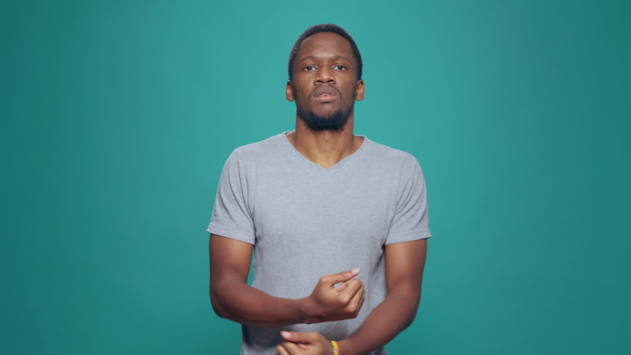 Displeased man doing stop gesture with arms on camera