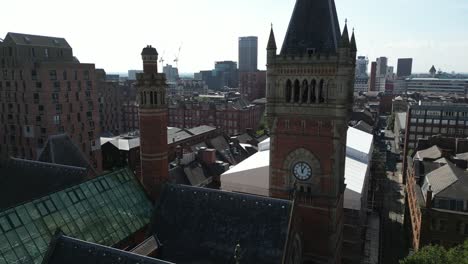 aerial drone flight around manchester crown court clocktower giving a view of the manchester skyline with the skyscrapers in the background