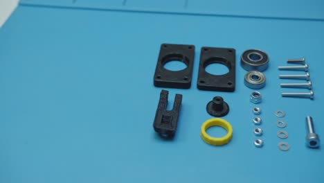 pan left small parts prepared for assembly blue background