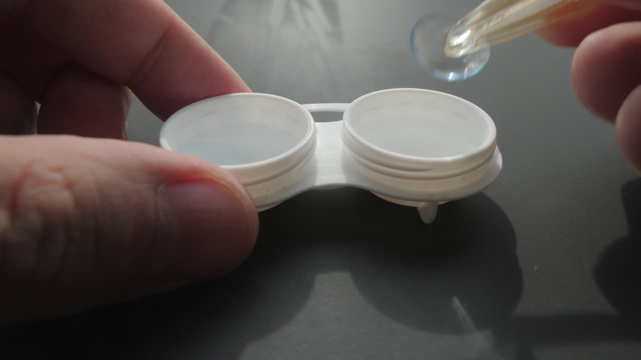 Putting contact lenses in a case