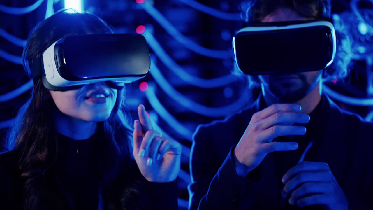 A man and a woman using Virtual Reality headsets in a server room