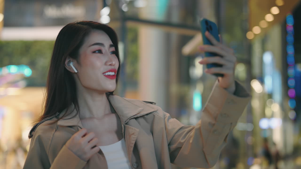Woman taking a selfie at night in the city