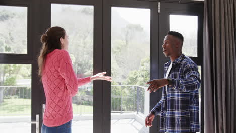 Angry-diverse-couple-arguing-by-window-at-home,-slow-motion