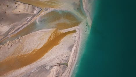 aerial top down descending on glacial floodplain delta with orange sandy deposits