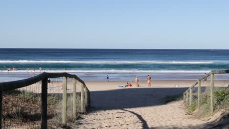 scenic beach view through wooden pathway entrance