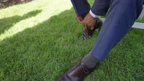 groom tying his shoelaces