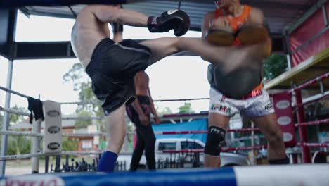 muay thai training session in a boxing ring
