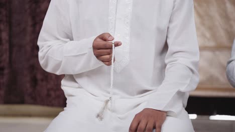 religious indian man using praying beads