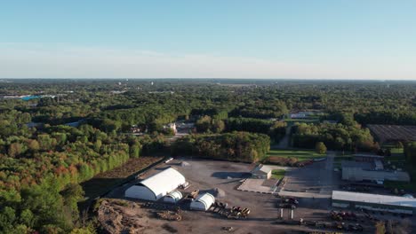 An-aerial-shot-of-beautiful-vast-land-surrounded-by-green-trees-and-shrubs-in-the-morning-time