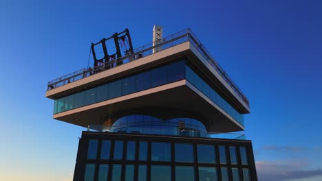 Swinging-at-Adam-observation-deck-rooftop-at-sunset-in-Dutch-capital