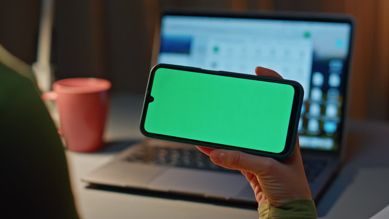 Unrecognizable girl watching chroma key smartphone social media working evening