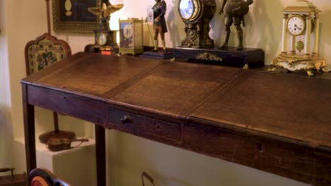 antique writing table with vintage clocks on top old fashioned used historic item 19th century smooth motion